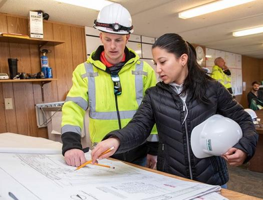 Construction students looking at blueprints